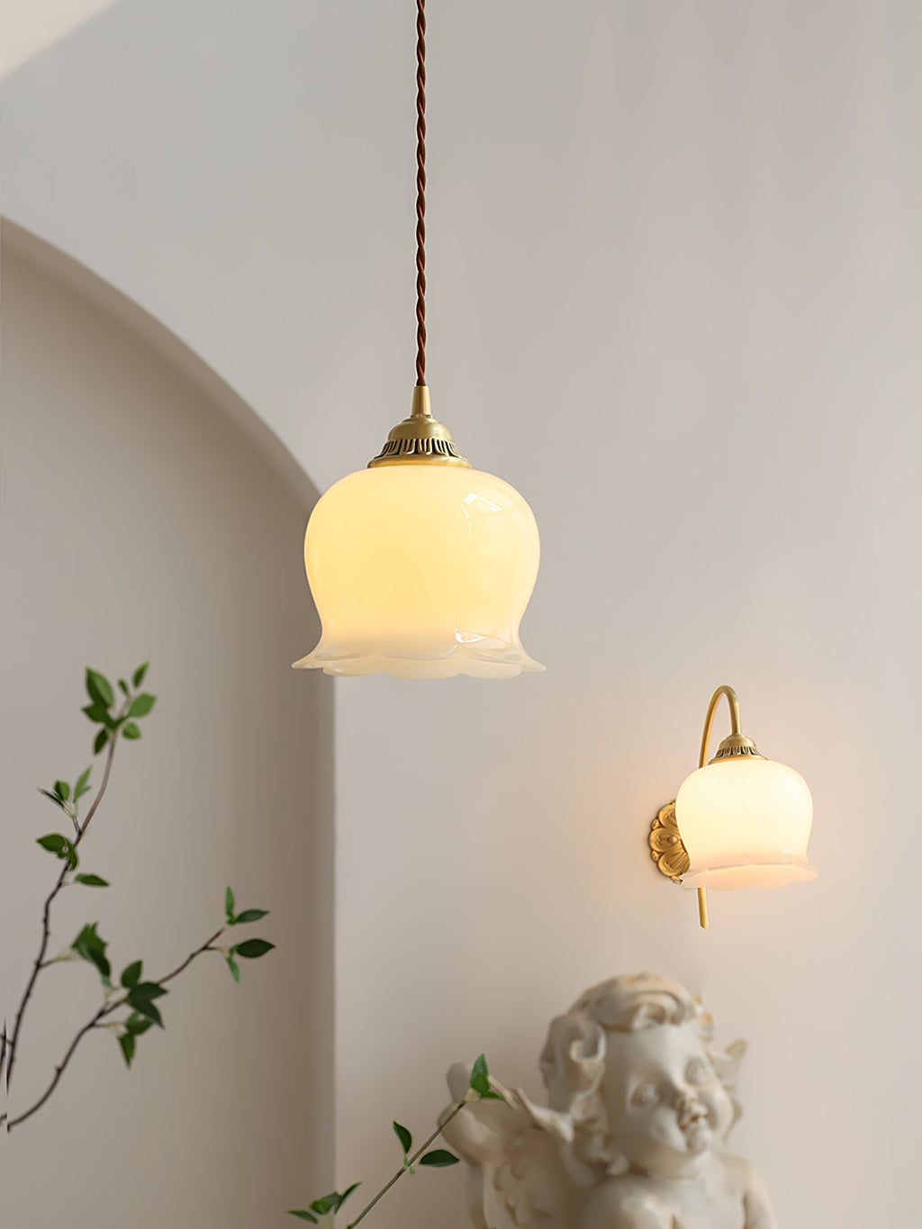 Brass flower pendant light glowing softly above a side table