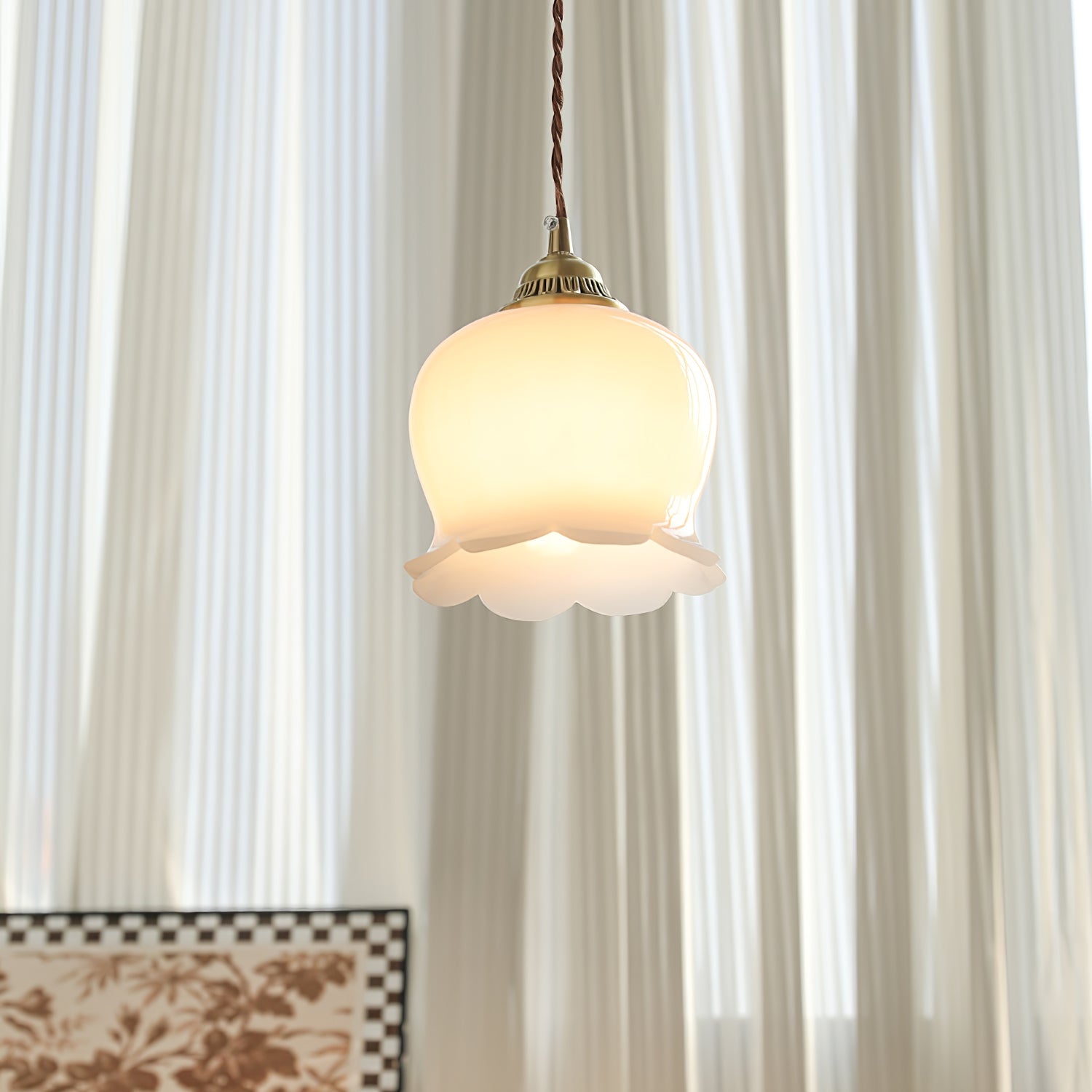 Brass pendant light with sculpted petal shade viewed from below