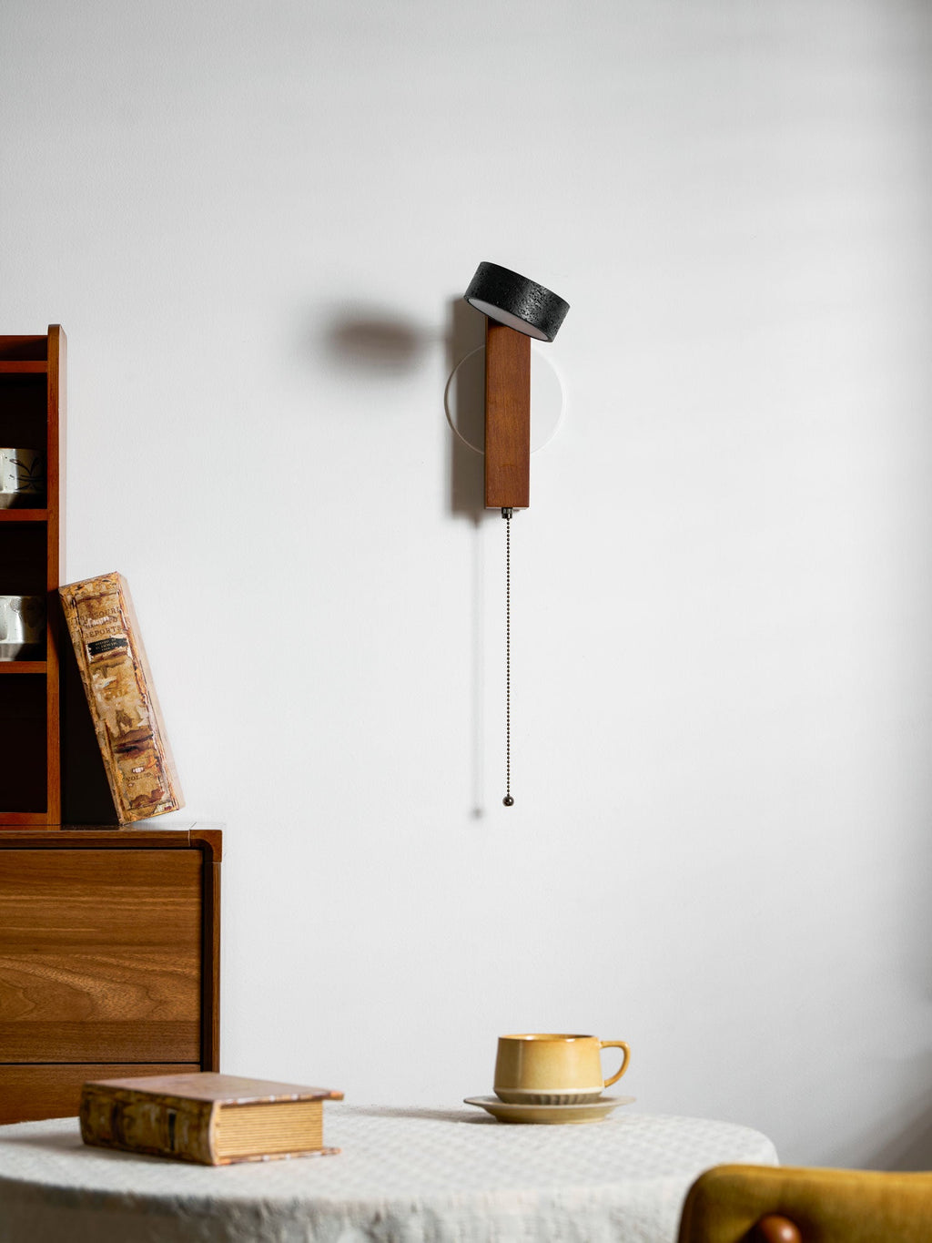 Turned side-on, this Clérachic wall light shows its walnut arm to the fore against the cream wall.