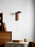 Turned partway around, this Clérachic wall light shows its black travertine shade in profile.