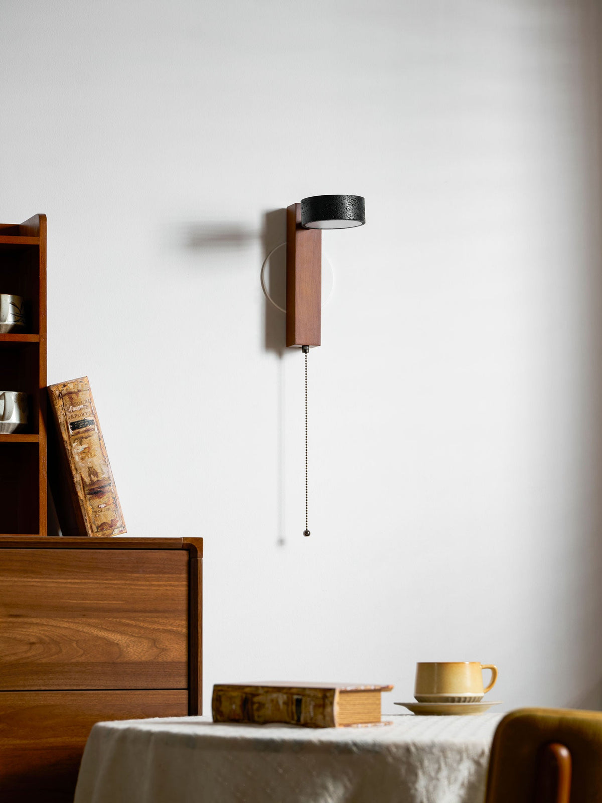Turned partway around, this Clérachic wall light shows its black travertine shade in profile.