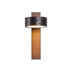 Straight-on product shot of this Clérachic wall light, the walnut bar rising to a black travertine drum shade.