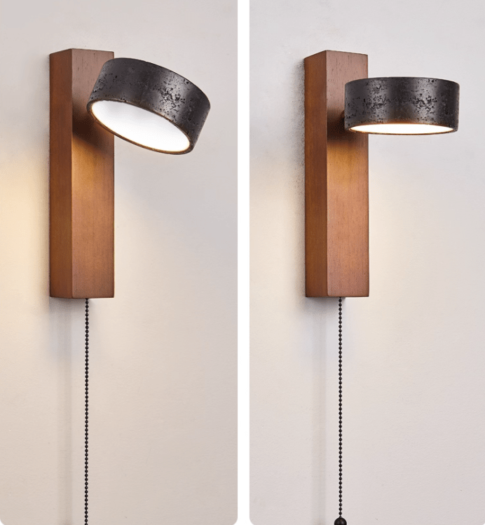 This Clérachic wall light shown pivoted to two positions, its black travertine head swivelling on the walnut bar.