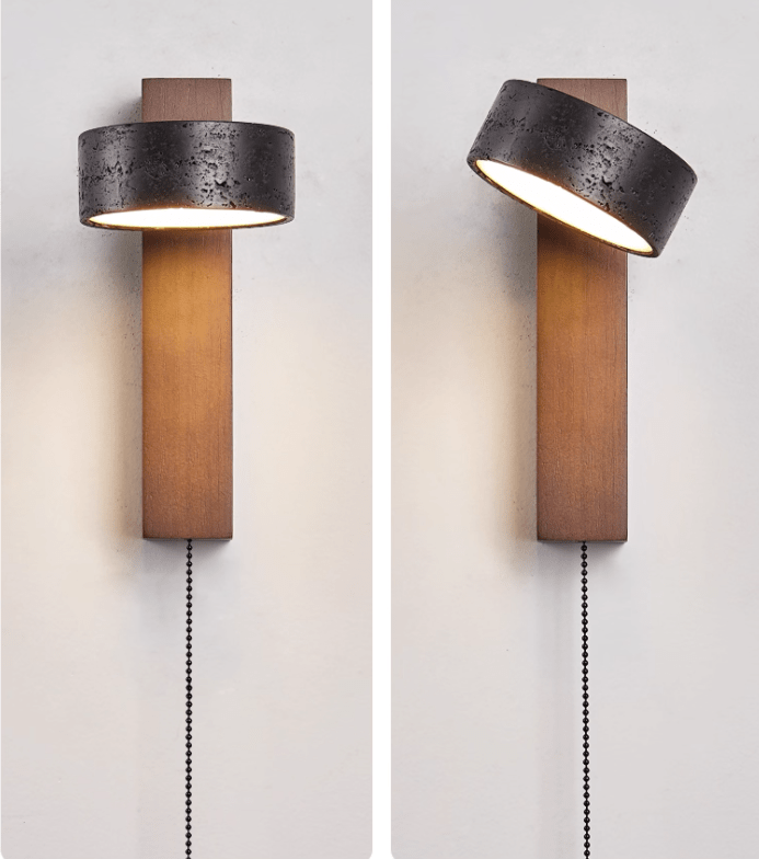 This Clérachic wall light shown swivelled to two angles, the pull chain hanging from the walnut wood base.