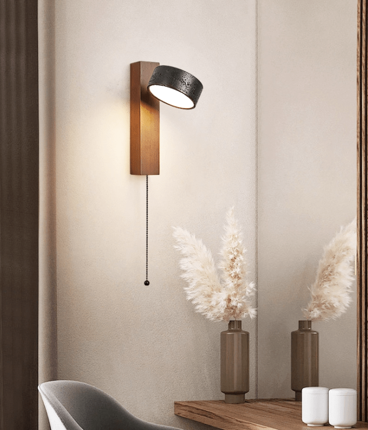 Beside a mirror reflecting dried pampas grass in vases, this Clérachic wall light glows warm on the wall.