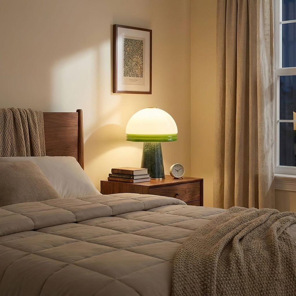 On a walnut nightstand, this Clérachic dome lamp glows beside a bedside clock and a stack of books at dusk.