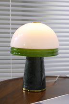 An isolated, close view of the Clérachic dome lamp lit on the round table with no other props in frame.