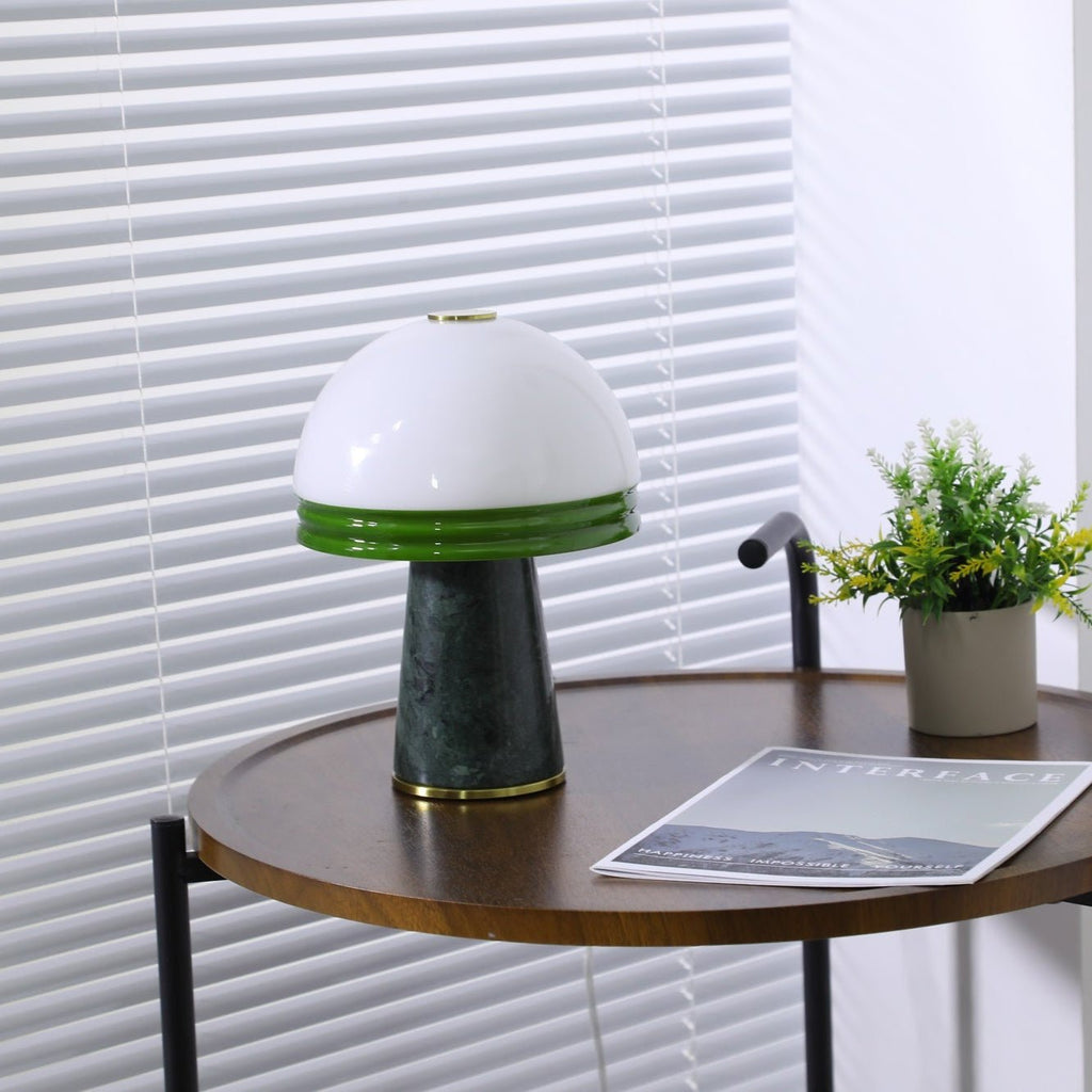 A wider angle shows the lit Clérachic dome lamp with its green rim, a plant and magazine both in frame.