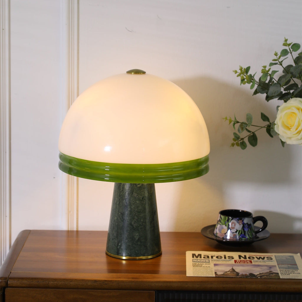 Seen from a slightly higher angle, the Clérachic dome table lamp lights the same cabinet, showing the green shade band.