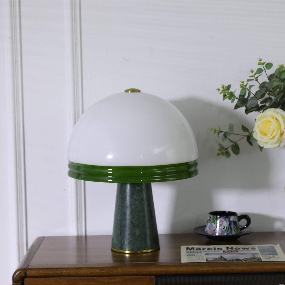 Clérachic dome table lamp shown unlit on a cabinet, its green marble base clearly visible beside a teacup and rose.