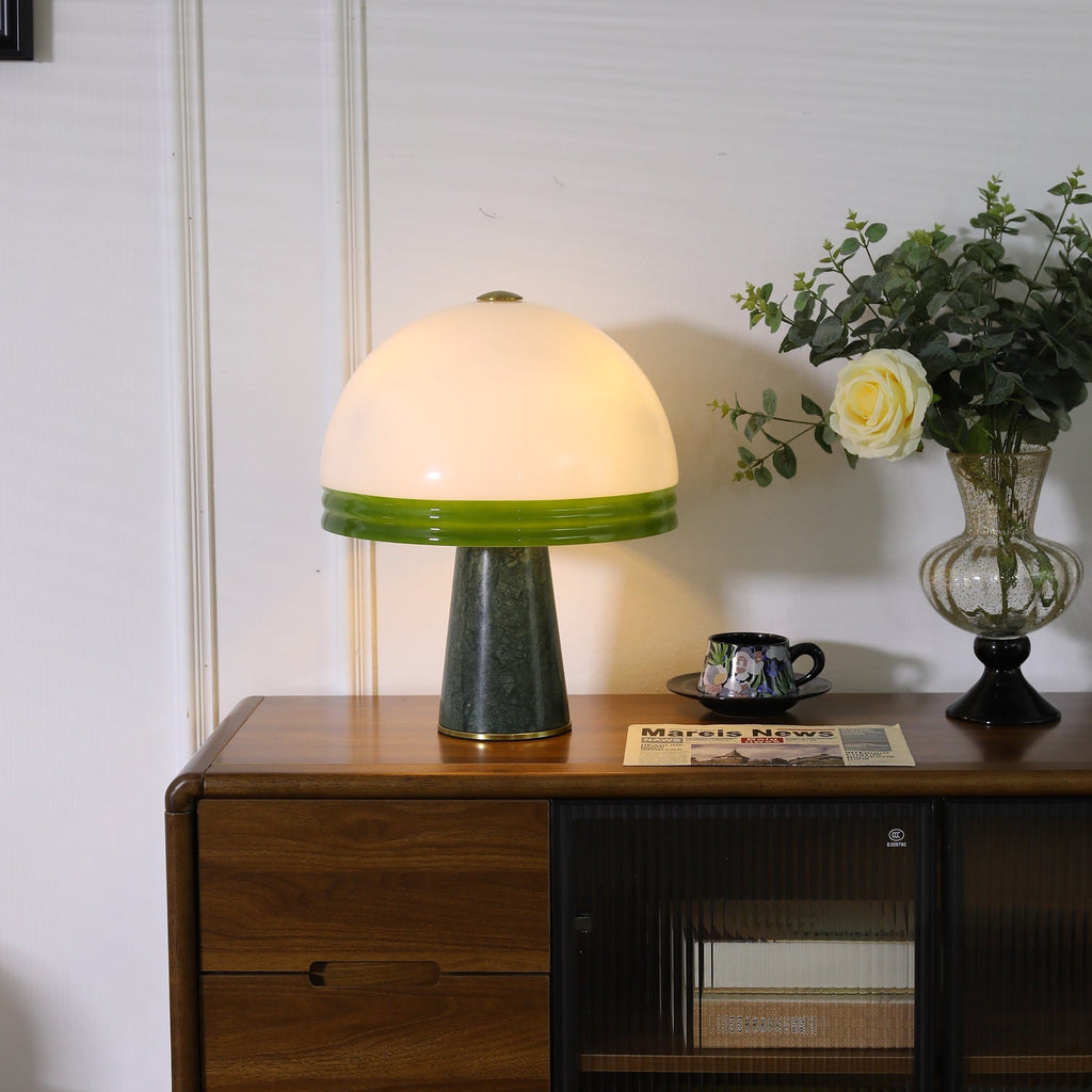 Clérachic dome table lamp glowing warmly on a cabinet, its white dome bright beside a vase of cream roses.
