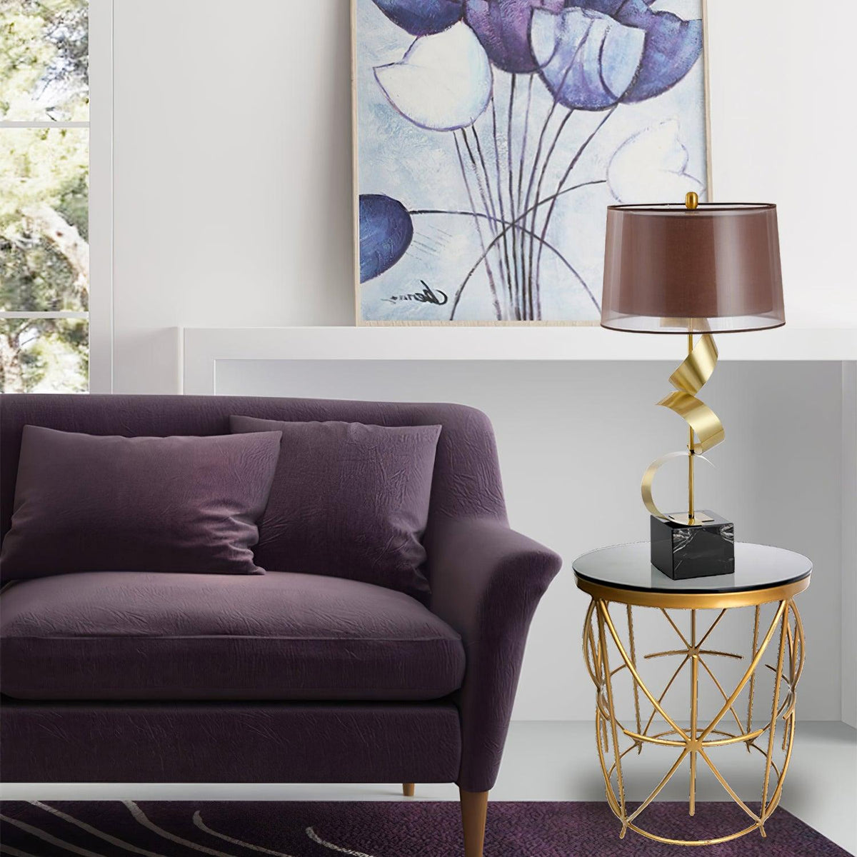 In a styled living room, the Clérachic gold spiral lamp sits on a small glass-and-gold table beside a purple velvet sofa.