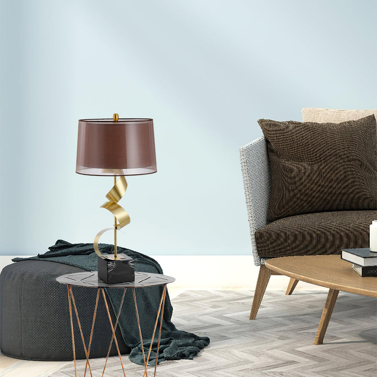A teal pouf and woven armchair share this pale blue room with the Clérachic gold spiral lamp on its round glass table.
