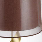 Macro detail of the Clérachic drum shade's woven fabric texture and pale inner lining above the gold spiral stem.