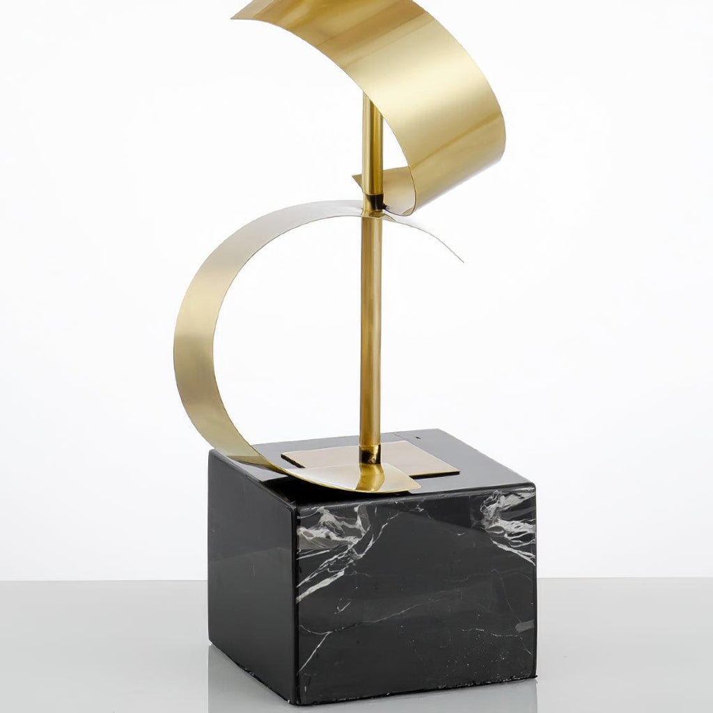Isolated close-up of the Clérachic lamp's coiled gold ribbon stem against a white background, with no shade attached.