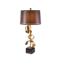 Clérachic table lamp with a warm brown drum shade and twisted gold spiral stem, photographed against a white backdrop.