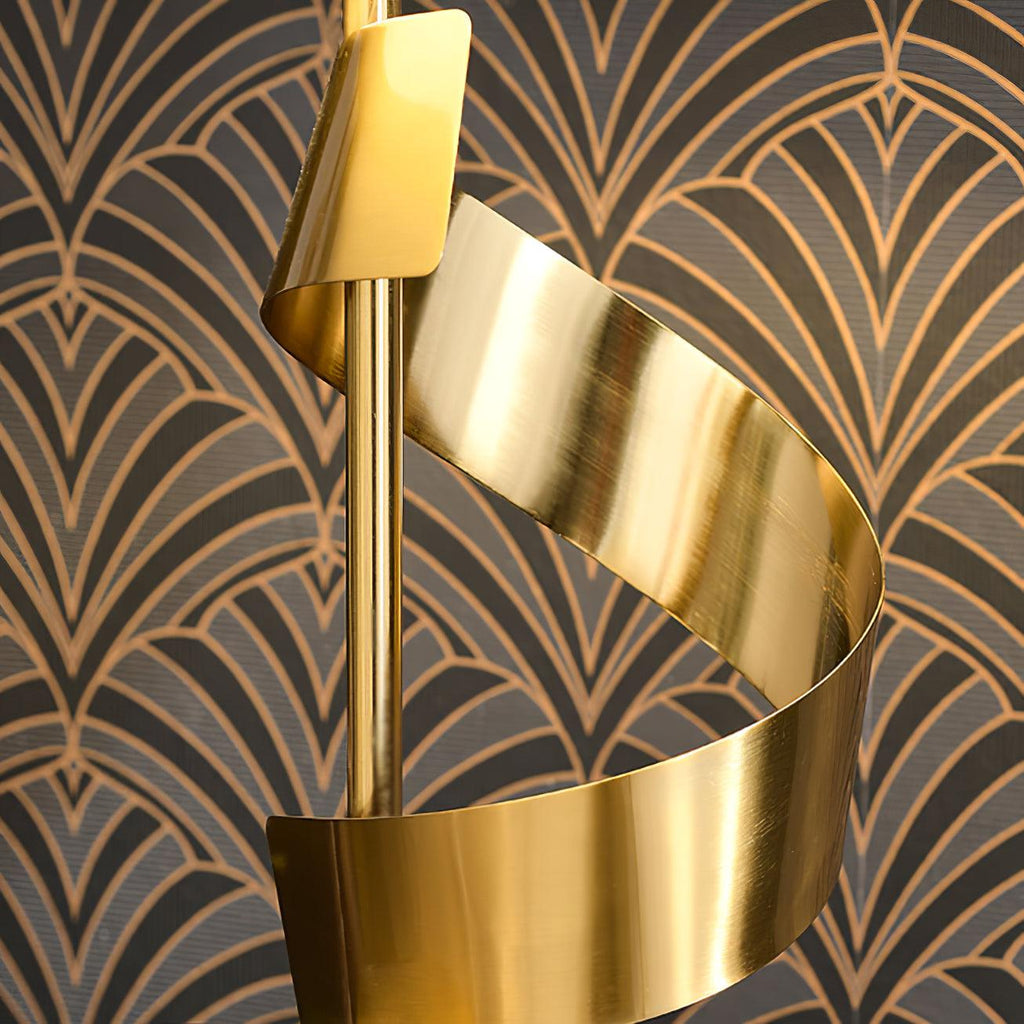 Macro detail of the Clérachic gold ribbon spiral coiling around its stem, set against dark art-deco patterned wallpaper.