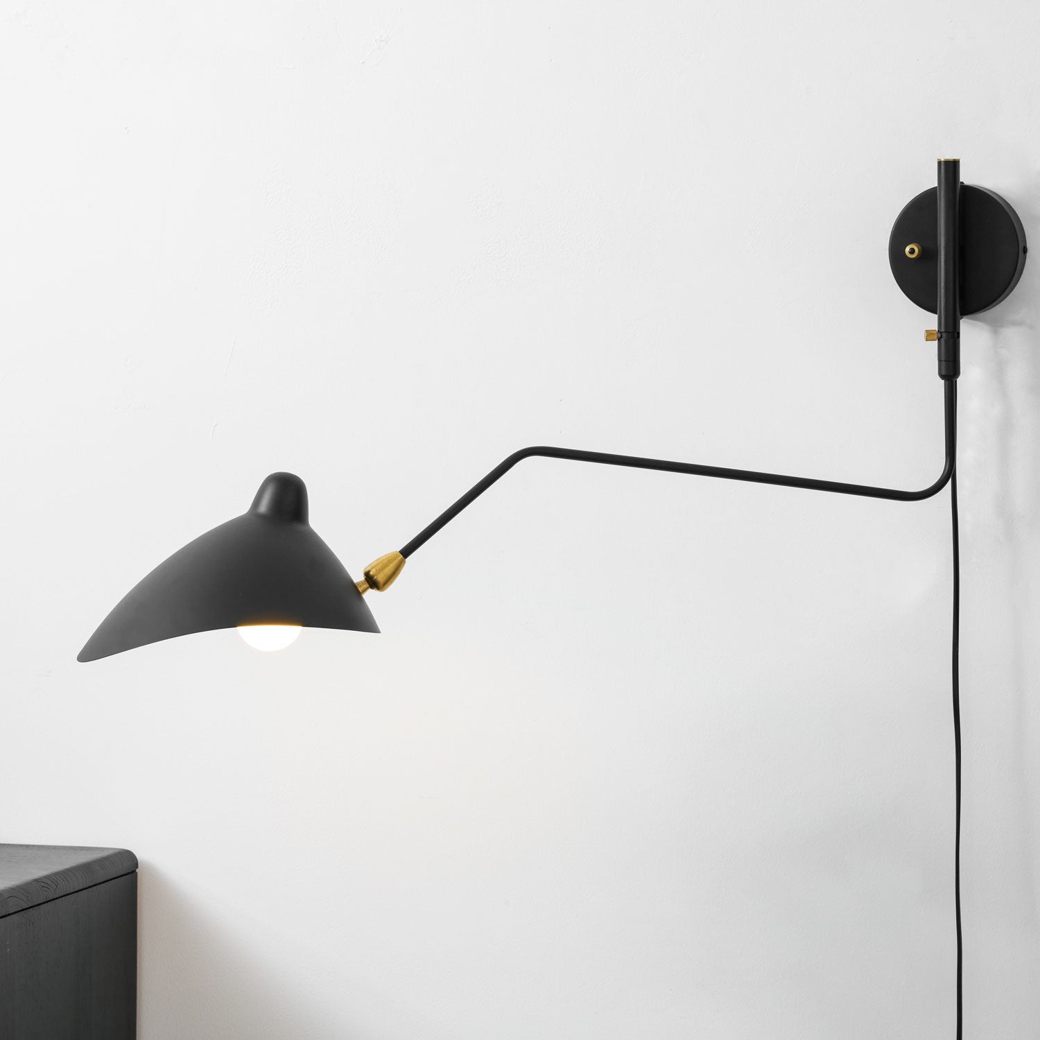 Adjustable wall sconce angled over a console table