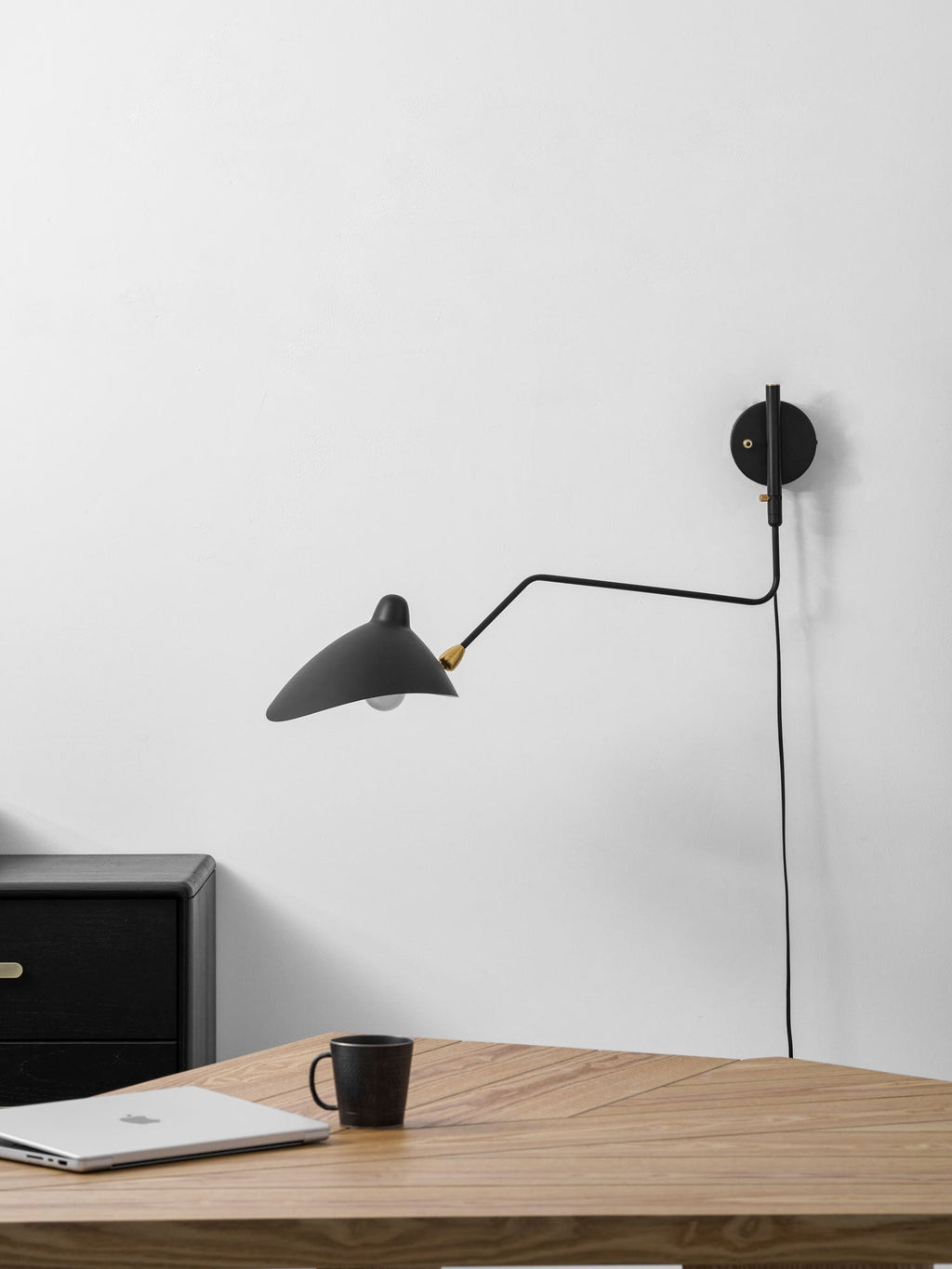 Plug-in wall sconce with cord routed neatly down the wall