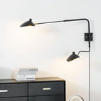 Swing-arm wall sconce extended over a small side table