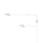 Versatile arm wall sconce angled downward over a seating area
