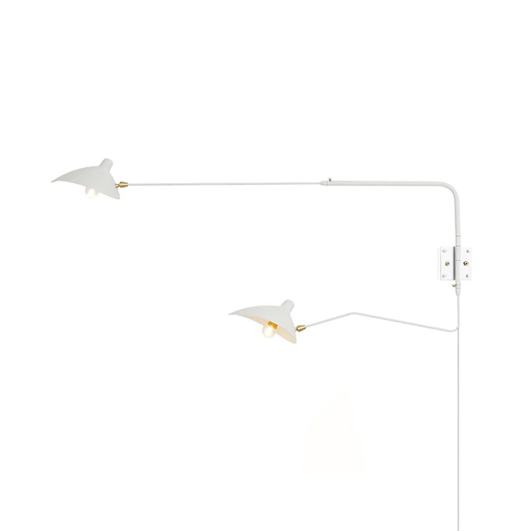 Versatile arm wall sconce angled downward over a seating area