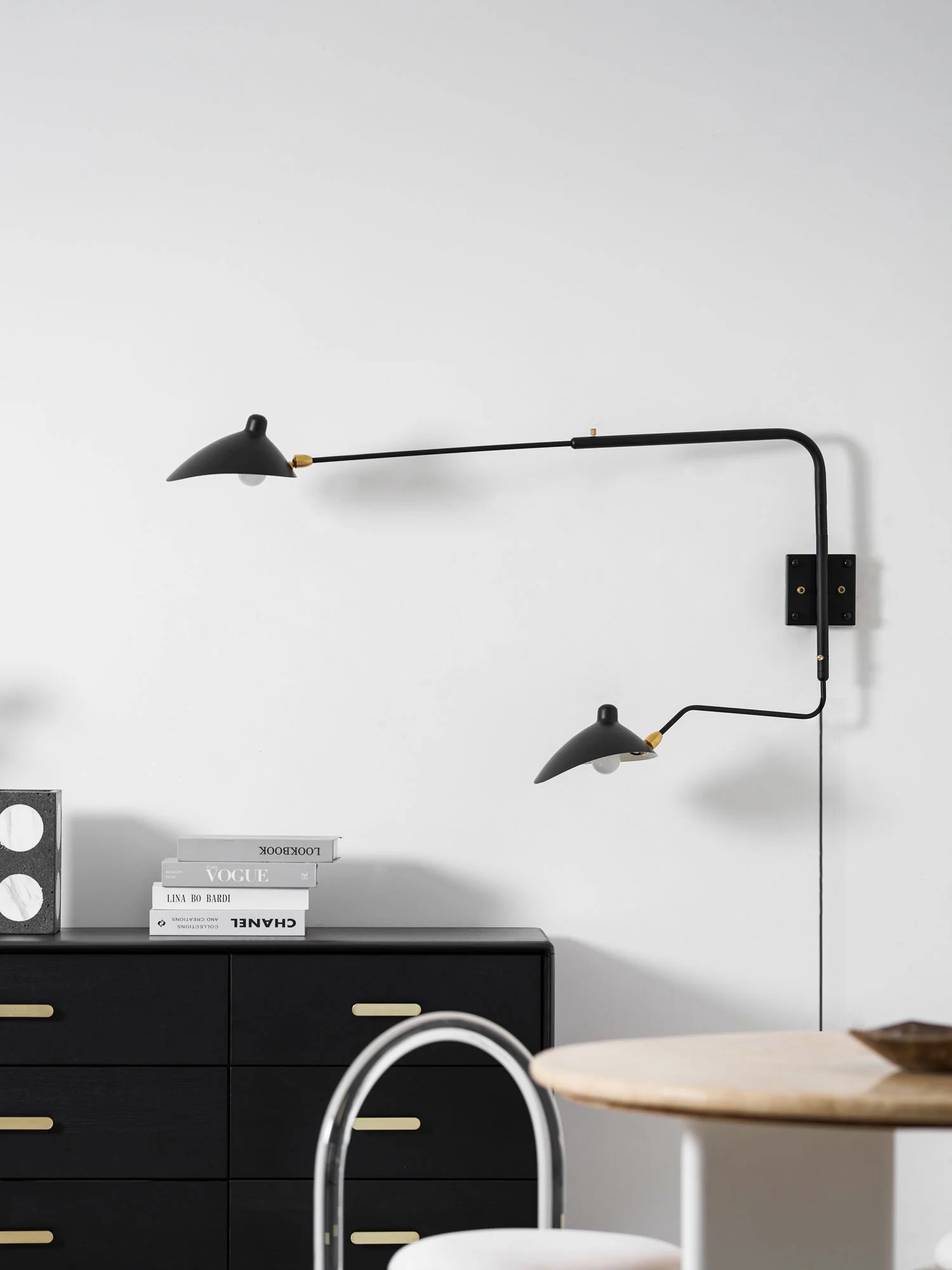 Versatile arm wall sconce against a neutral living room backdrop