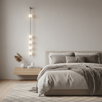 Vertical balls wall lamp illustrated against a plain backdrop