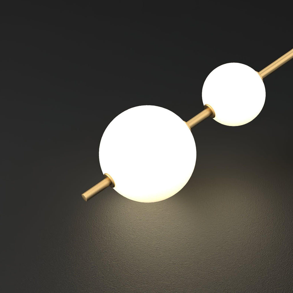 Glass globe pendant light lit beside a window