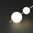 Glass globe pendant light lit beside a window