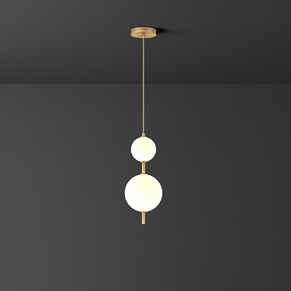 Glass globe pendant light glowing over a kitchen island
