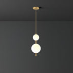 Glass globe pendant light glowing over a kitchen island