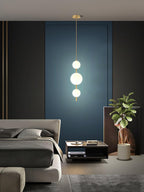 Glass globe pendant light hanging over a bar area