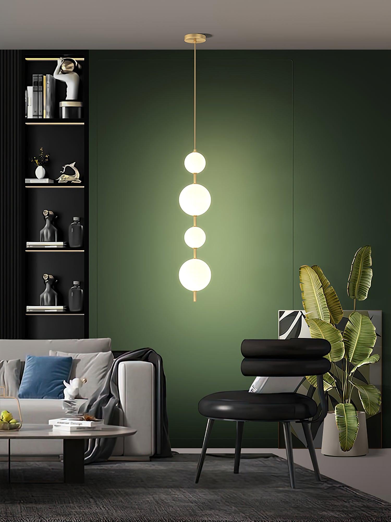 Glass globe pendant light lit above a counter