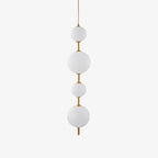 Cluster of globe pendant lights at varied lengths