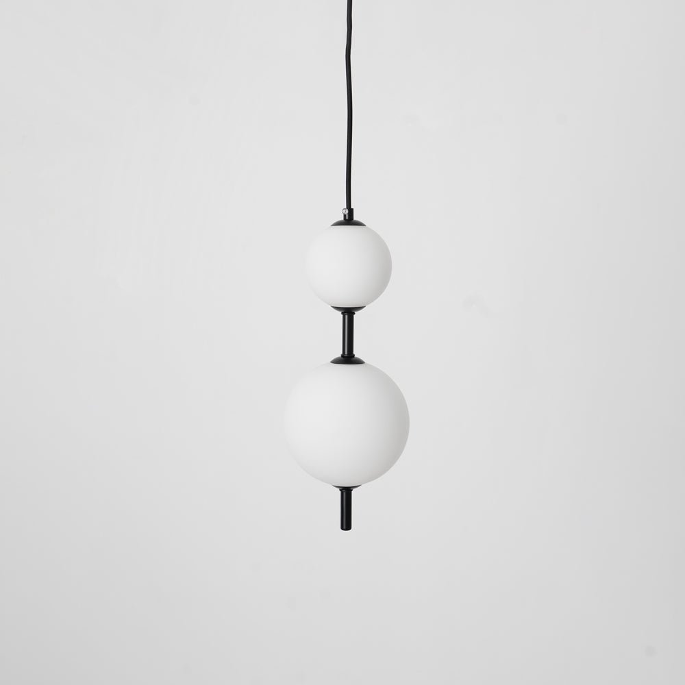 Glass globe pendant light with slim brass stem hanging