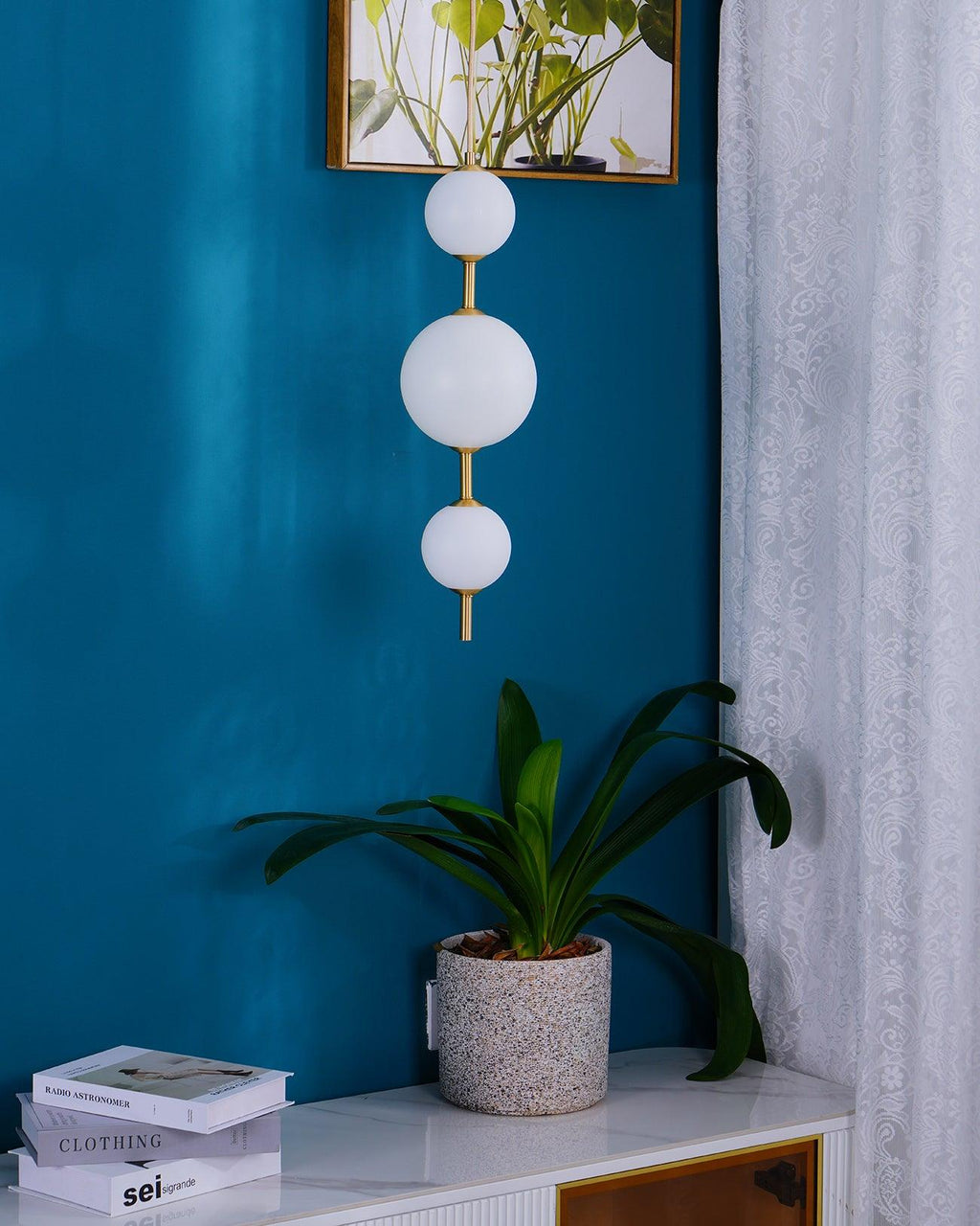 Single globe pendant light lit against a dark wall