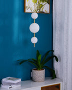 Single globe pendant light lit against a dark wall