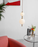 Vertical globe pendant lights grouped above a table