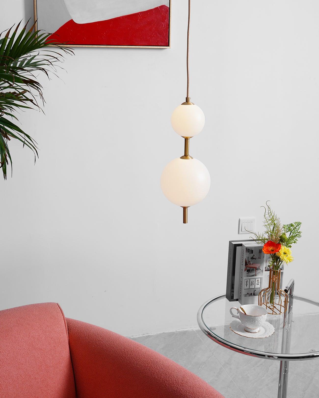 Vertical globe pendant lights grouped above a table