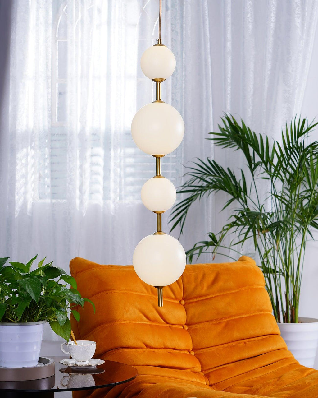 Globe pendant light with brass stem in a modern interior