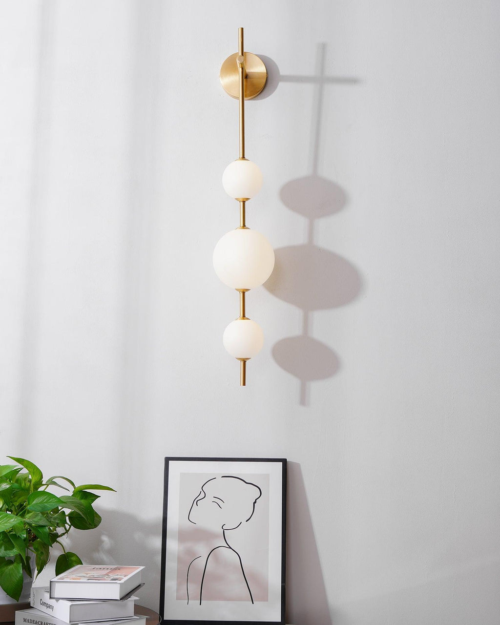 Vertical globe wall lamp lighting a softly furnished interior