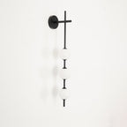 Black globe wall lamp detail showing matte white glass spheres
