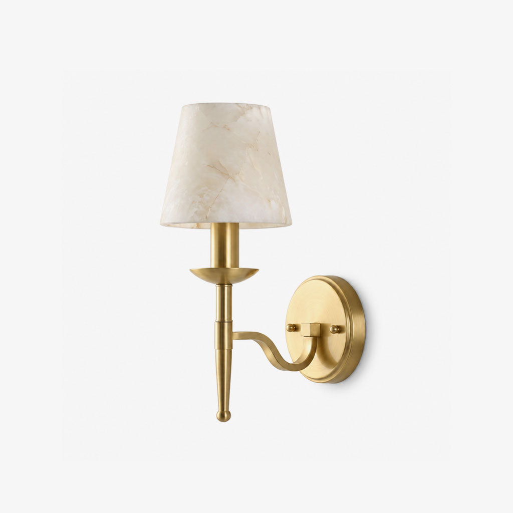 Close against a pale backdrop, this brass Clérachic sconce shows the bobeche drip pan beneath its cone shade.