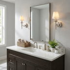 A nickel pair of these Clérachic sconces lights a bathroom mirror above a dark-wood vanity with woven baskets.