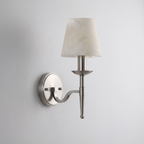 In brushed nickel, this Clérachic sconce curves its S-shaped arm up to a tapered alabaster cone shade.
