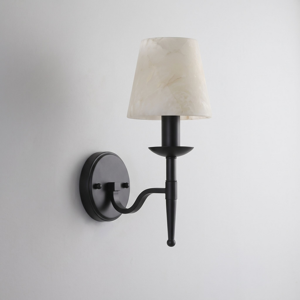 Photographed in matte black against grey, this Clérachic sconce holds its cone shade on a candle-style column.