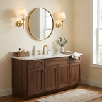 A brass pair of these Clérachic sconces flanks a round mirror above a walnut vanity in a cream-walled bathroom.