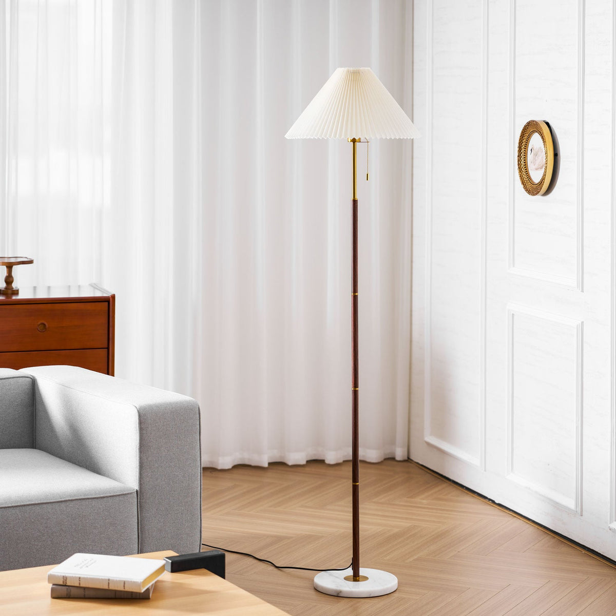 The same corner setting shows the Clérachic floor lamp's full pleated shade and white marble base beside the armchair.