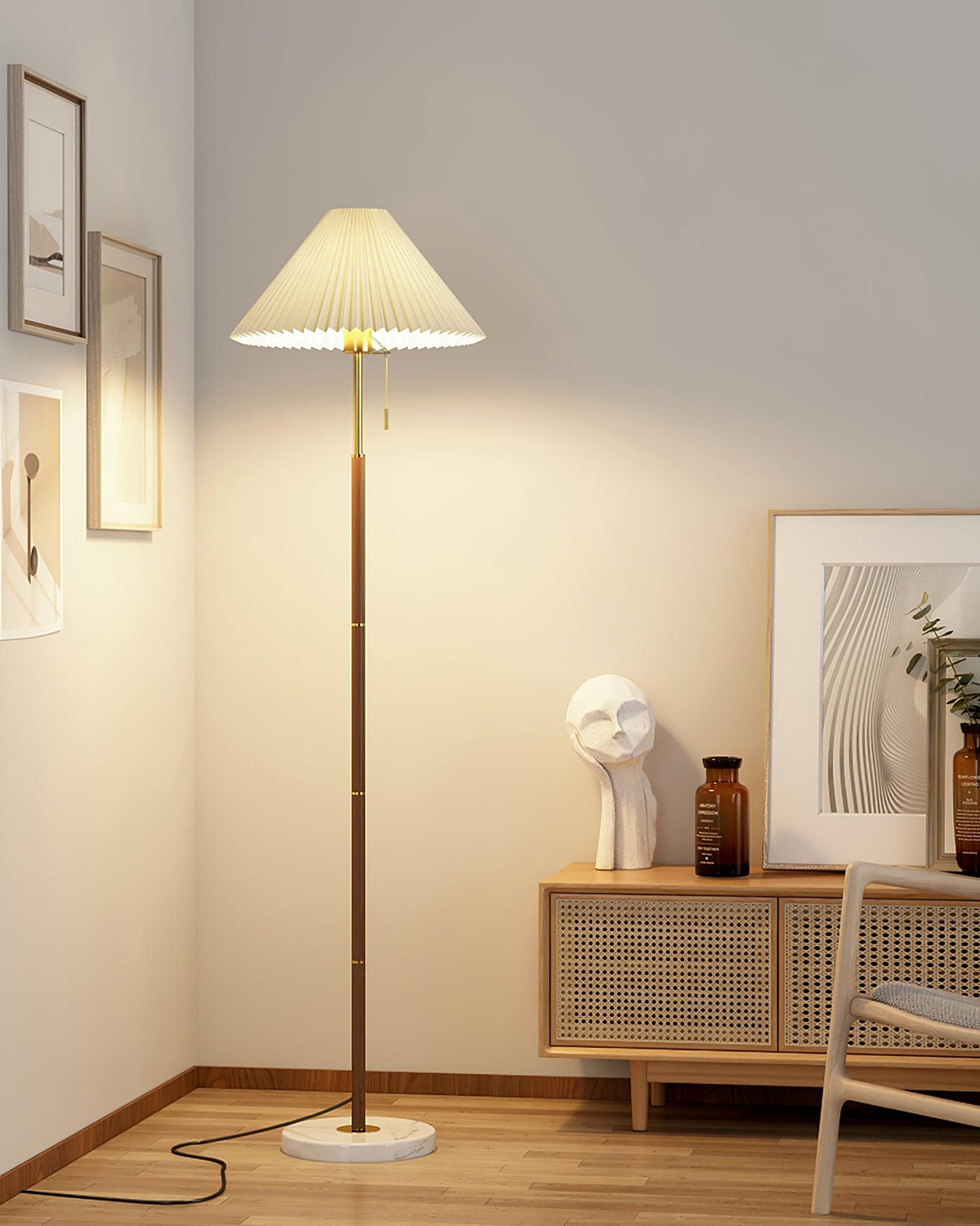 Clérachic pleated-shade floor lamp in a corner styled with framed art and a wood console holding a sculpture and vase.